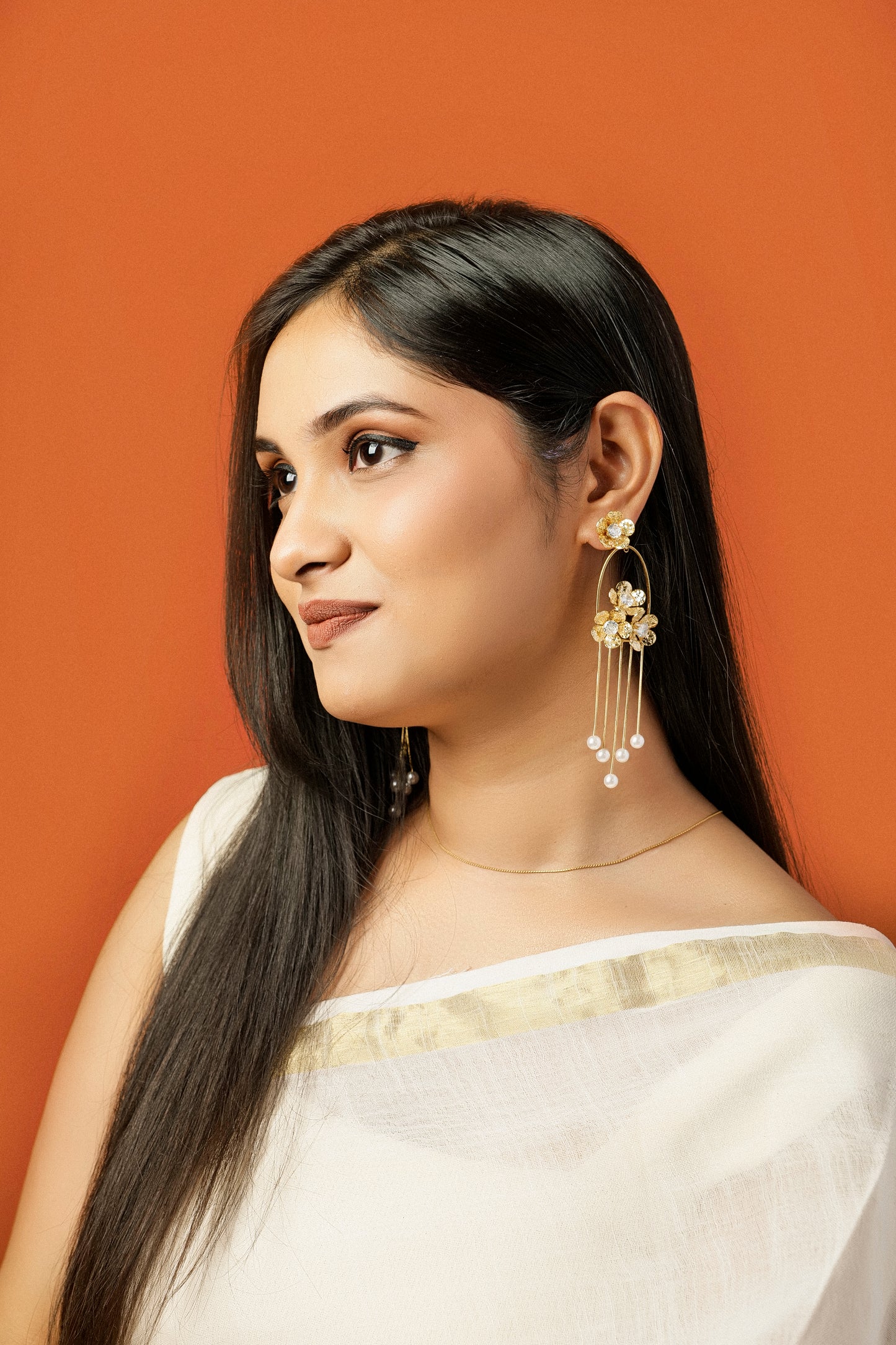 GOLDEN PEARL CASCADE STATEMENT EARRINGS.
