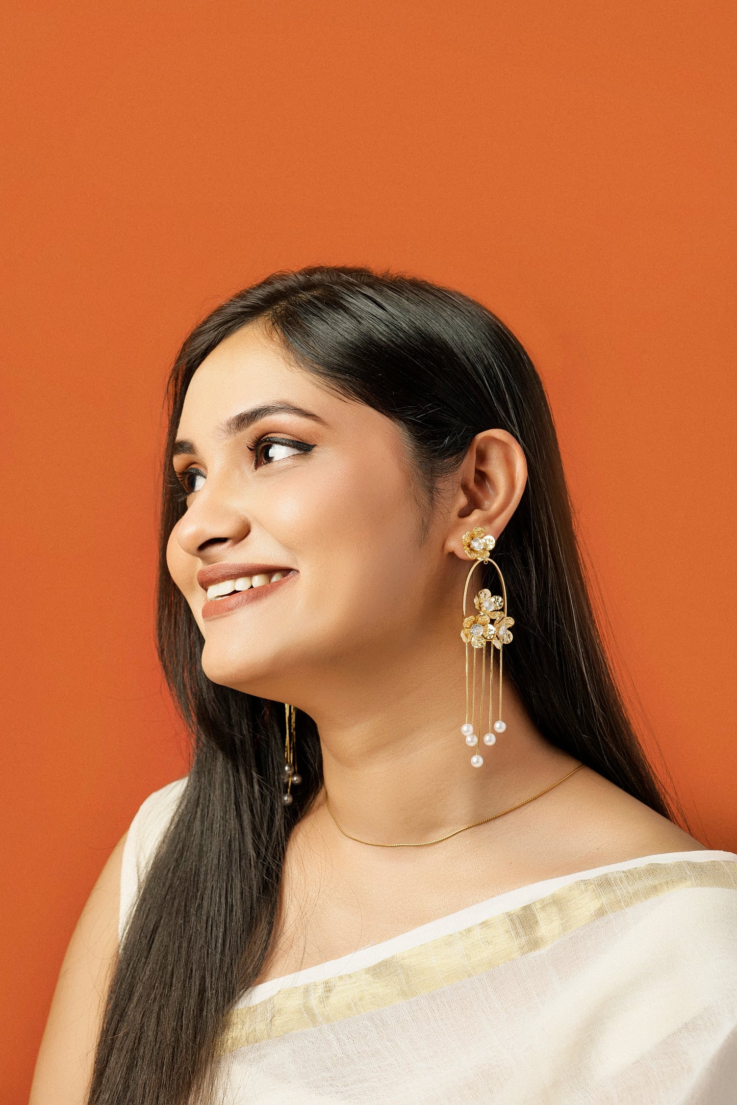 GOLDEN PEARL CASCADE STATEMENT EARRINGS.